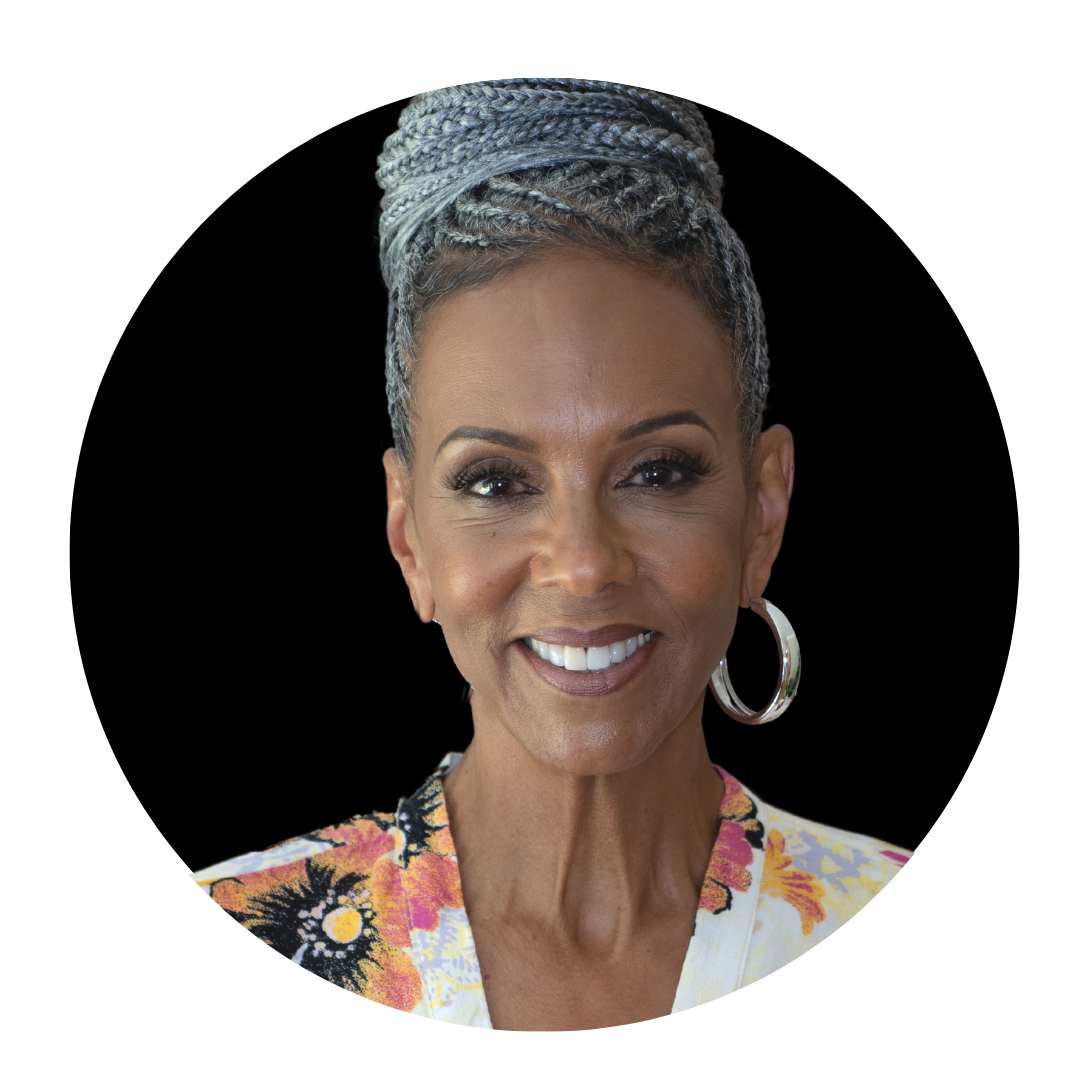 headshot of an older black woman with braids on top of her head, indoors