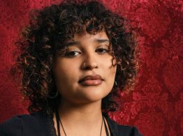 headshot of Angie Morales, Afro-Latinx woman with curly hair